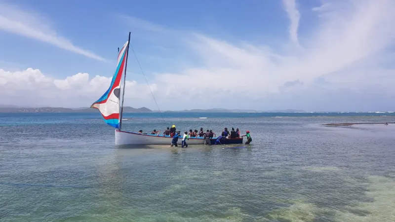 Une yole ronde voile hissée sur les fonds blancs du François